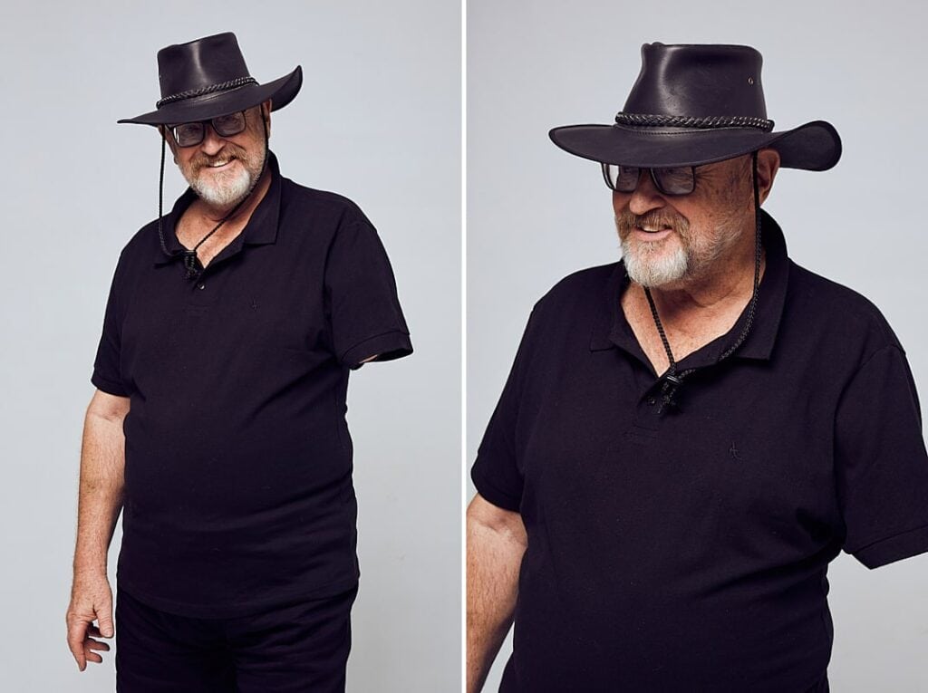 Personal branding photography of a man in his 60's with a black, leather cowboy hat and glasses dressed in all black. Shot in studio in Cape Town, South Africa